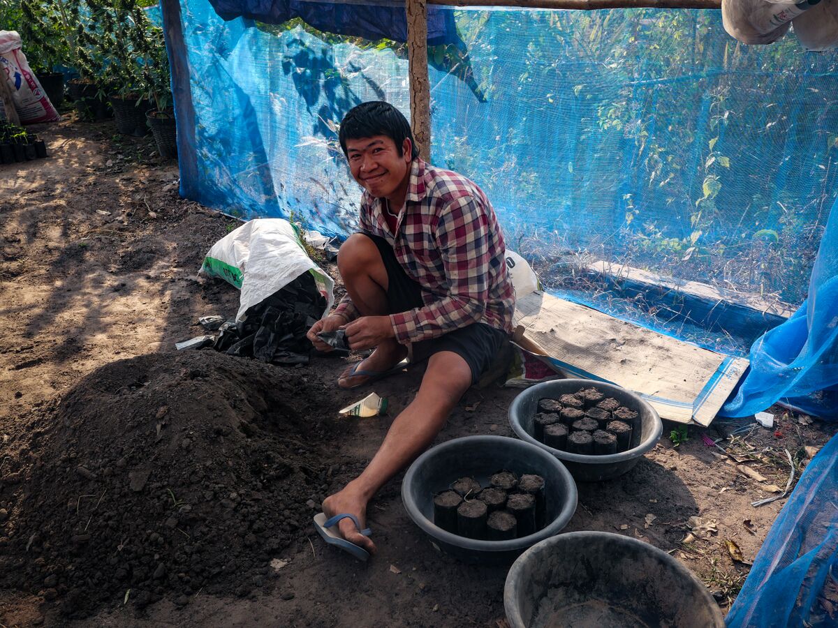 Khun Ta Lo mixing up some soil at his landrace cannabis farm in the Phu Phan mountains of Northeastern Thailand
